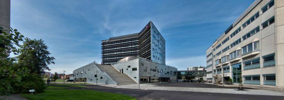 A building with stairs and grass
Description automatically generated