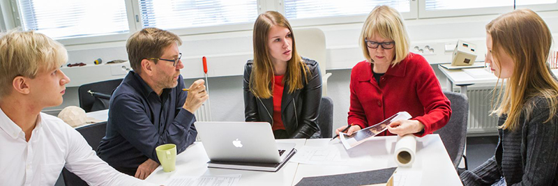 A group of women sitting at a table 
Description automatically generated