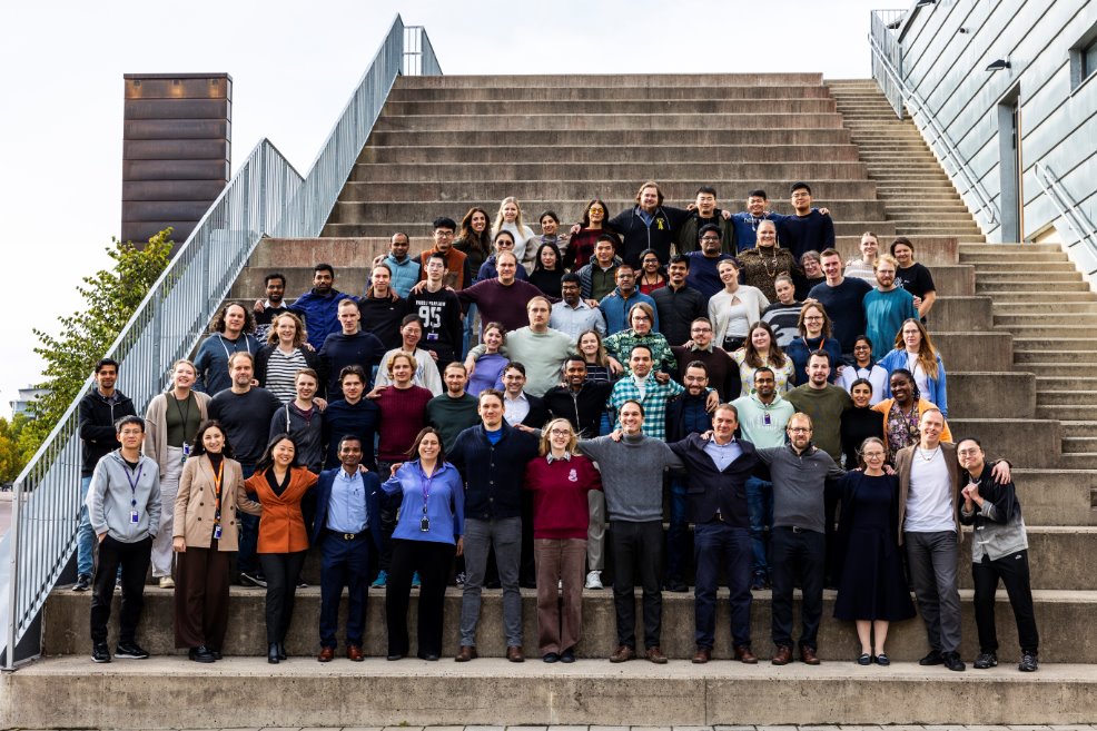 A group of people standing on stairs

Description automatically generated